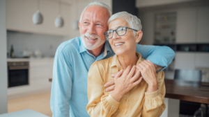 Reducing the risk of cognitive decline : two old people standing in their kitchen, holding each other.