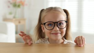 Glasses for children : a blonde child with glasses