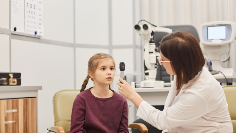 a picture of a child with an ophthalmologist for an examination for eye tracking disorders